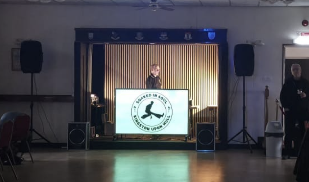 Northern Soul music event setup at Beverley Road Masonic Hall in Hull, featuring a DJ behind the decks and a dance floor.
